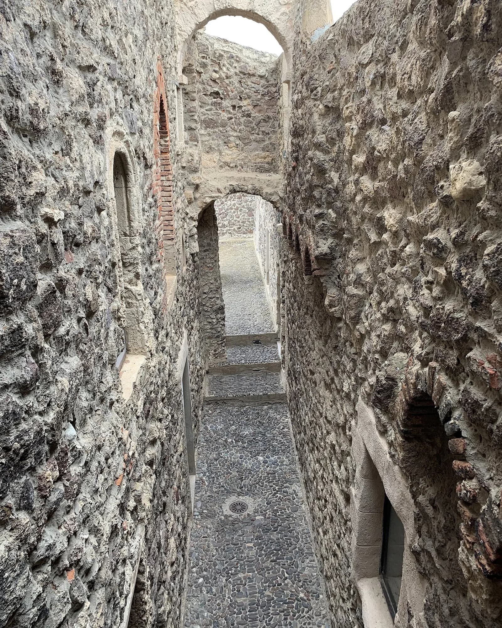 Ruelle étroite en pierre et passages voûtés dans le centre historique de Castelsardo